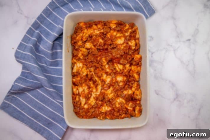 Puffy Pizza Bake 12 bubble up pizza mixture spread into baking dish.