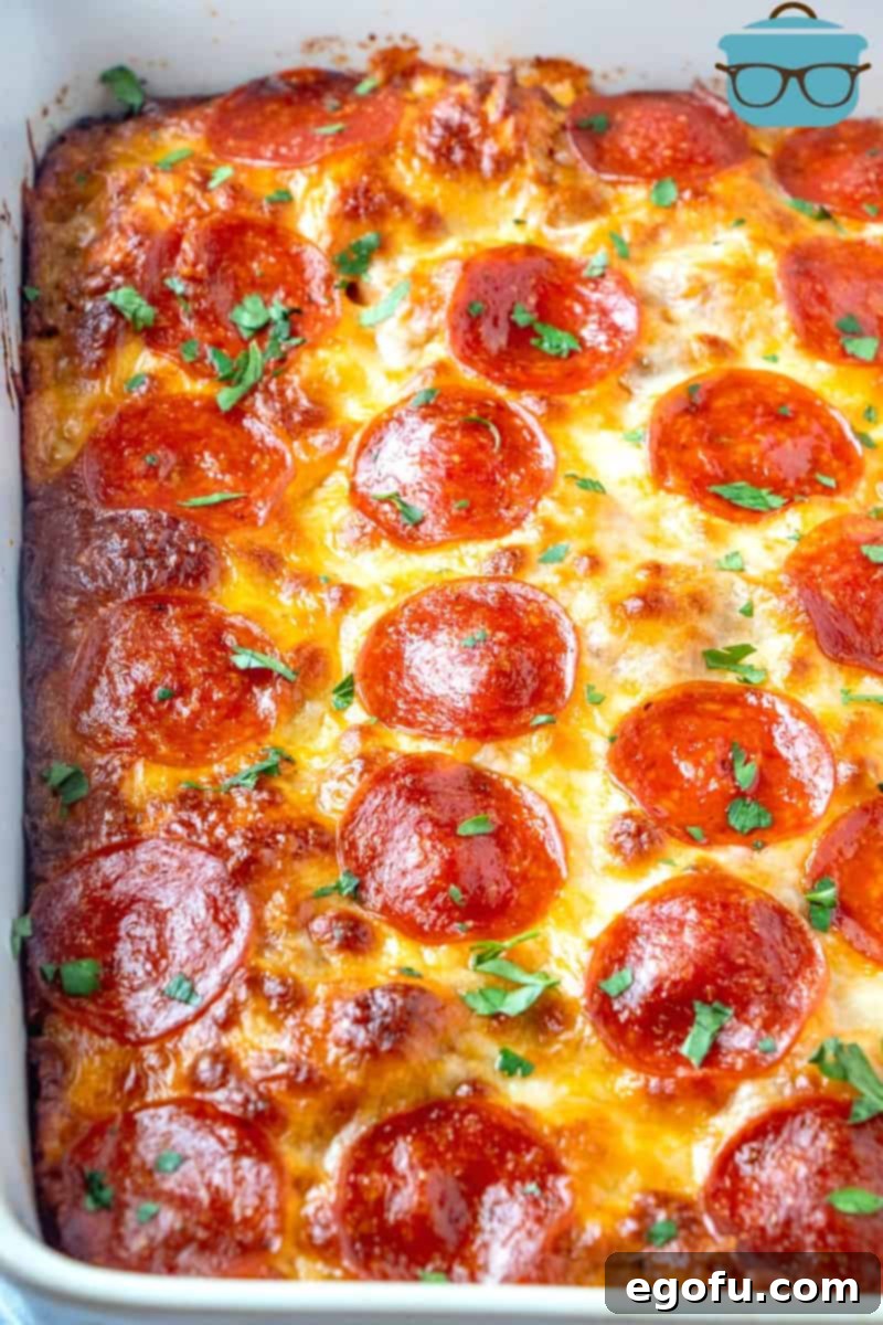 Puffy Pizza Bake 8 finished cooking, Bubble Up Biscuit Pizza Casserole topped with pepperoni and sprinkled with parsley.