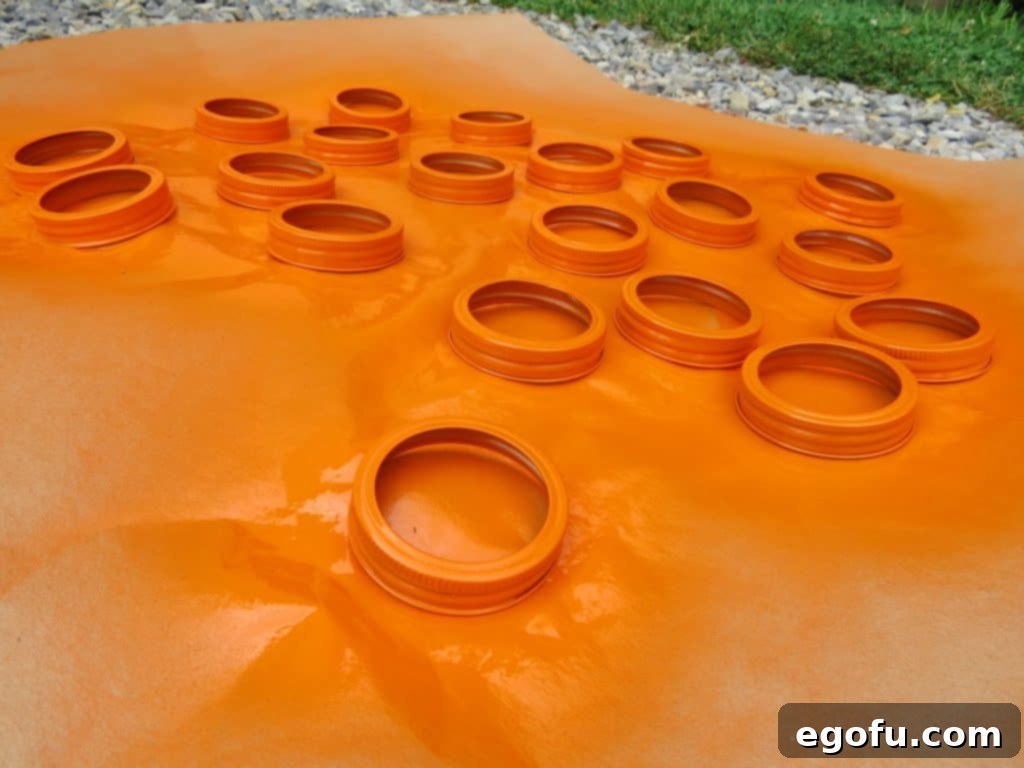 Autumn Jar Lid Pumpkins 5 freshly spray painted orange mason jar lids drying