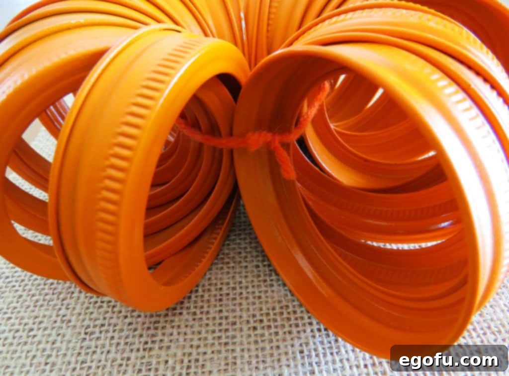 Autumn Jar Lid Pumpkins 7 close-up of tied orange mason jar lids forming a pumpkin base