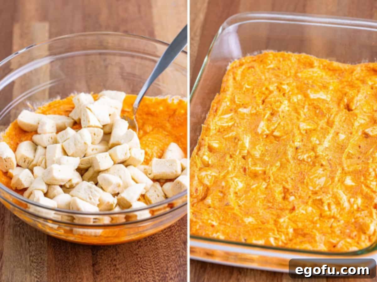 Small, cut biscuit pieces are mixed with the rich cheese and sauce mixture, then spread evenly into a baking dish to form the base layer of the Bubble Up Lasagna.