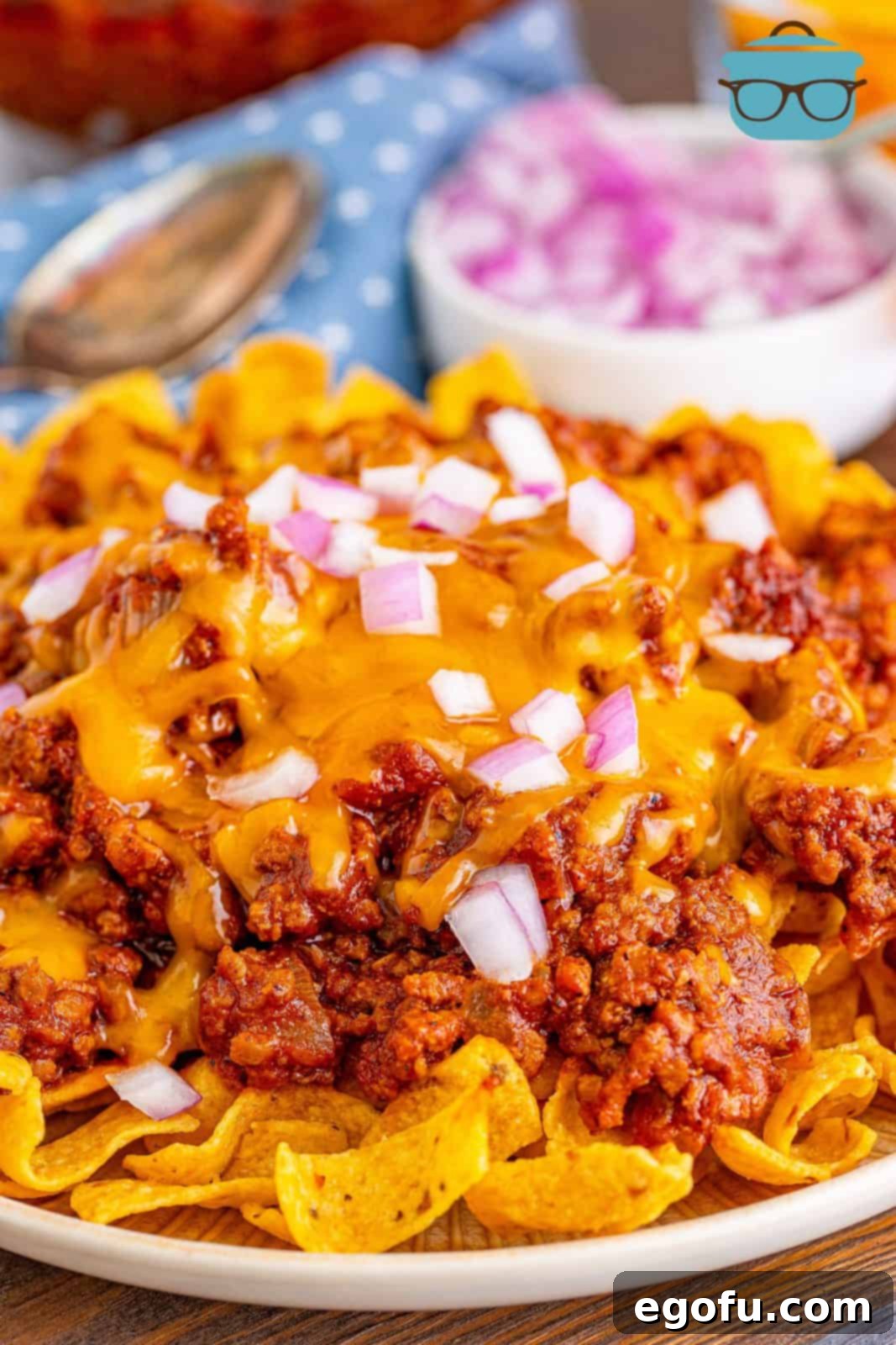 plated, chili on fritos on a white plate.