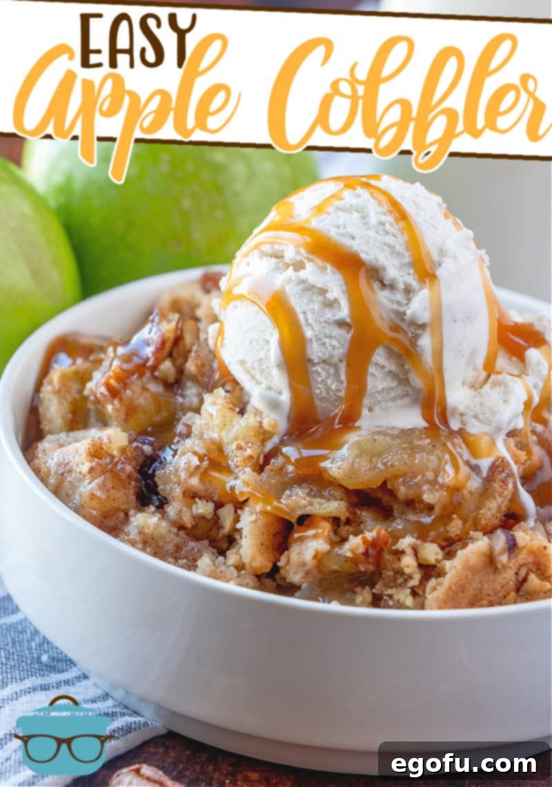 Easy Apple Cobbler recipe served in a white bowl with vanilla ice cream and caramel, accompanied by fresh green apples in the background.