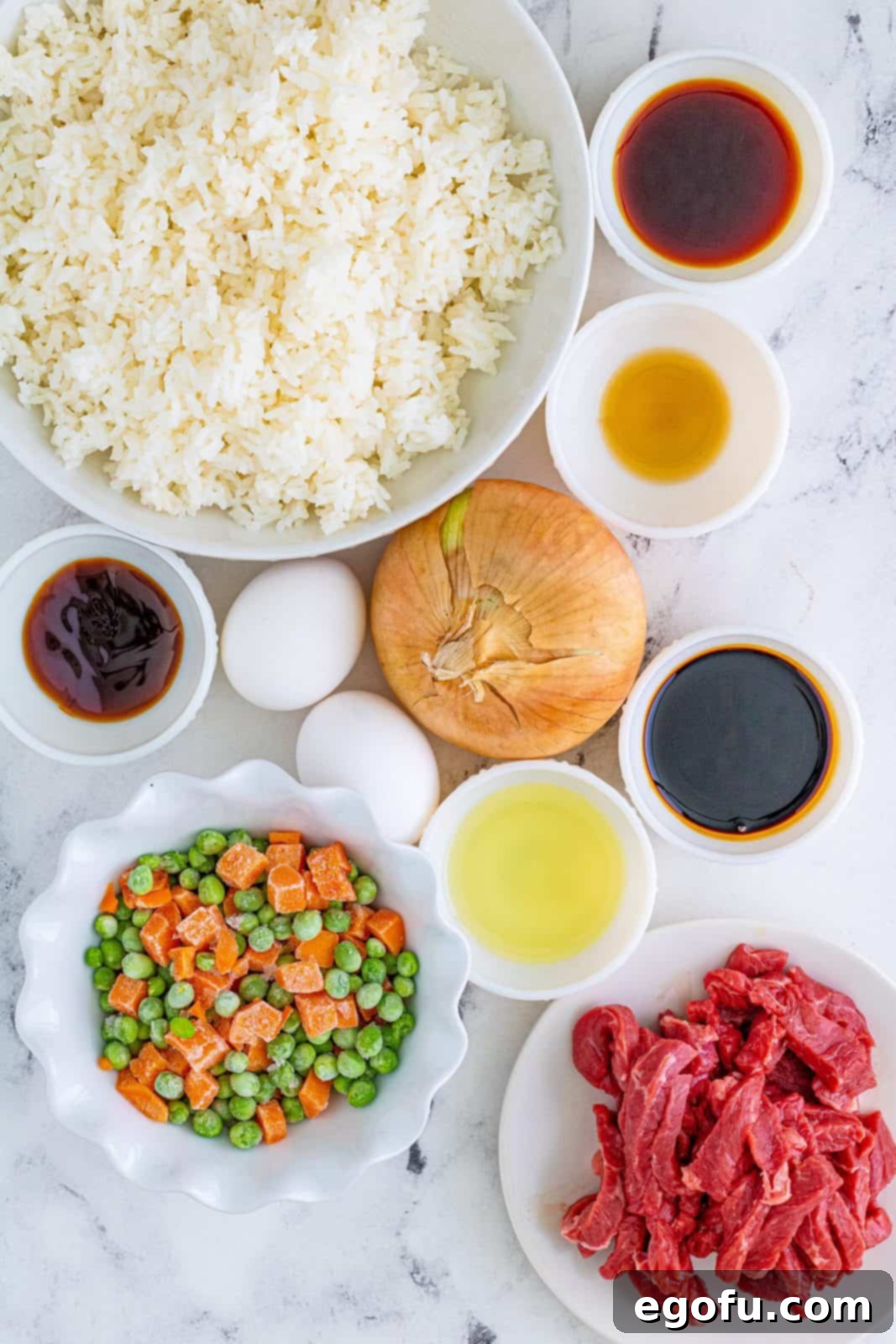 Sizzling Beef Fried Rice 4 Ingredients needed: dark soy sauce, soy sauce, oyster sauce, toasted sesame oil, vegetable oil, sirloin steak, onion, frozen peas and carrots, eggs, rice and scallions.