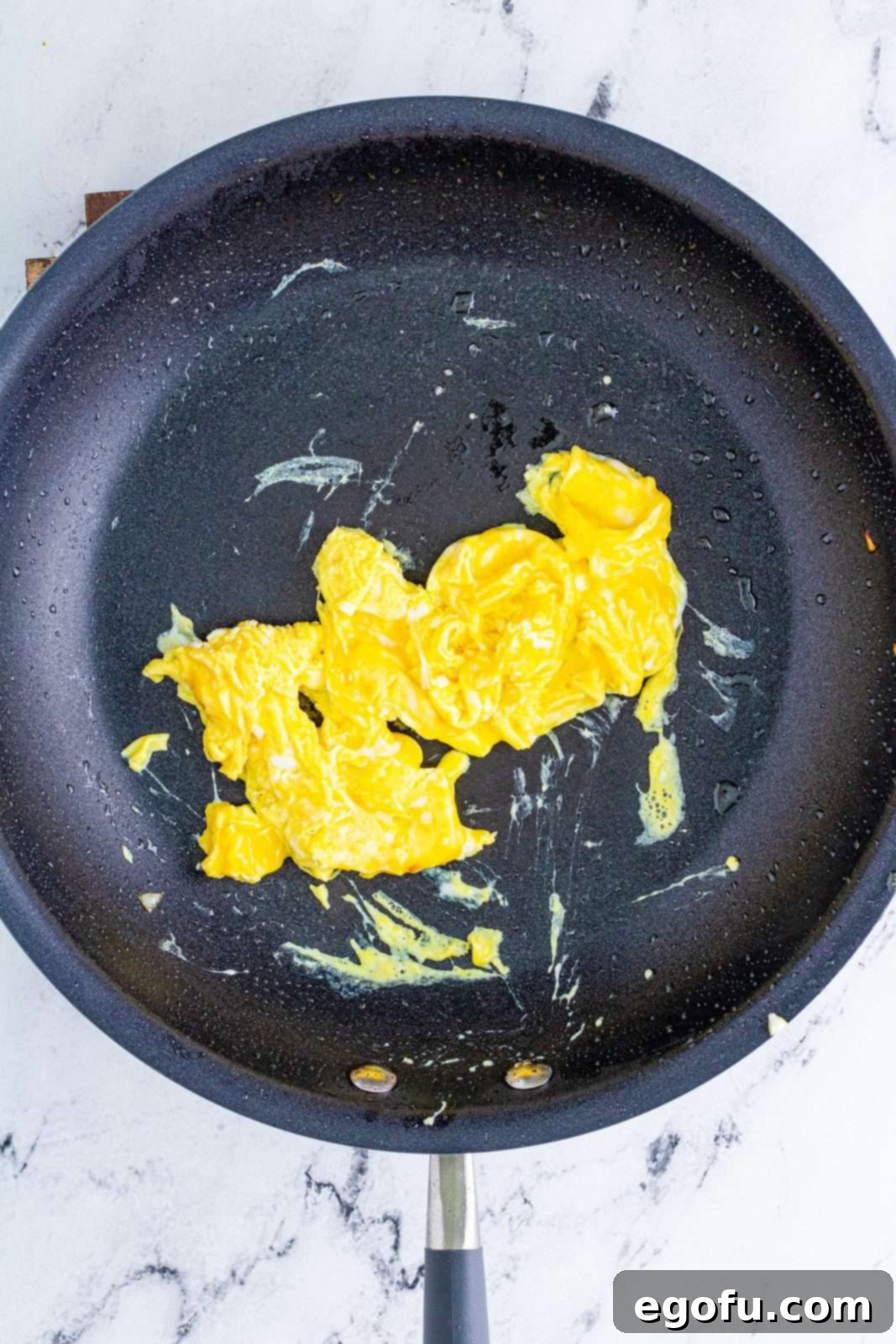 Sizzling Beef Fried Rice 7 Eggs being scrambled in pan.