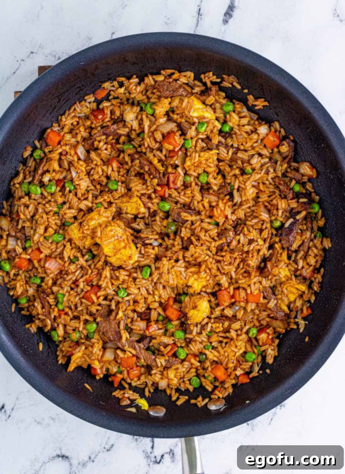 Sizzling Beef Fried Rice 10 Stirred up fried rice in pan.