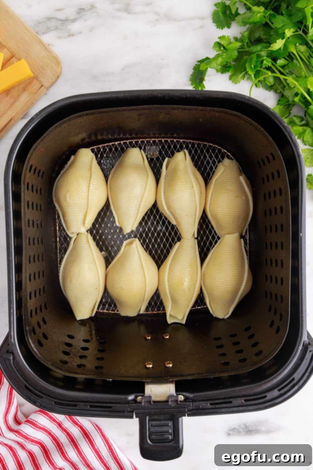 Crispy Air Fryer Taco Shells 7 Stuffed Shells placed in air fryer.