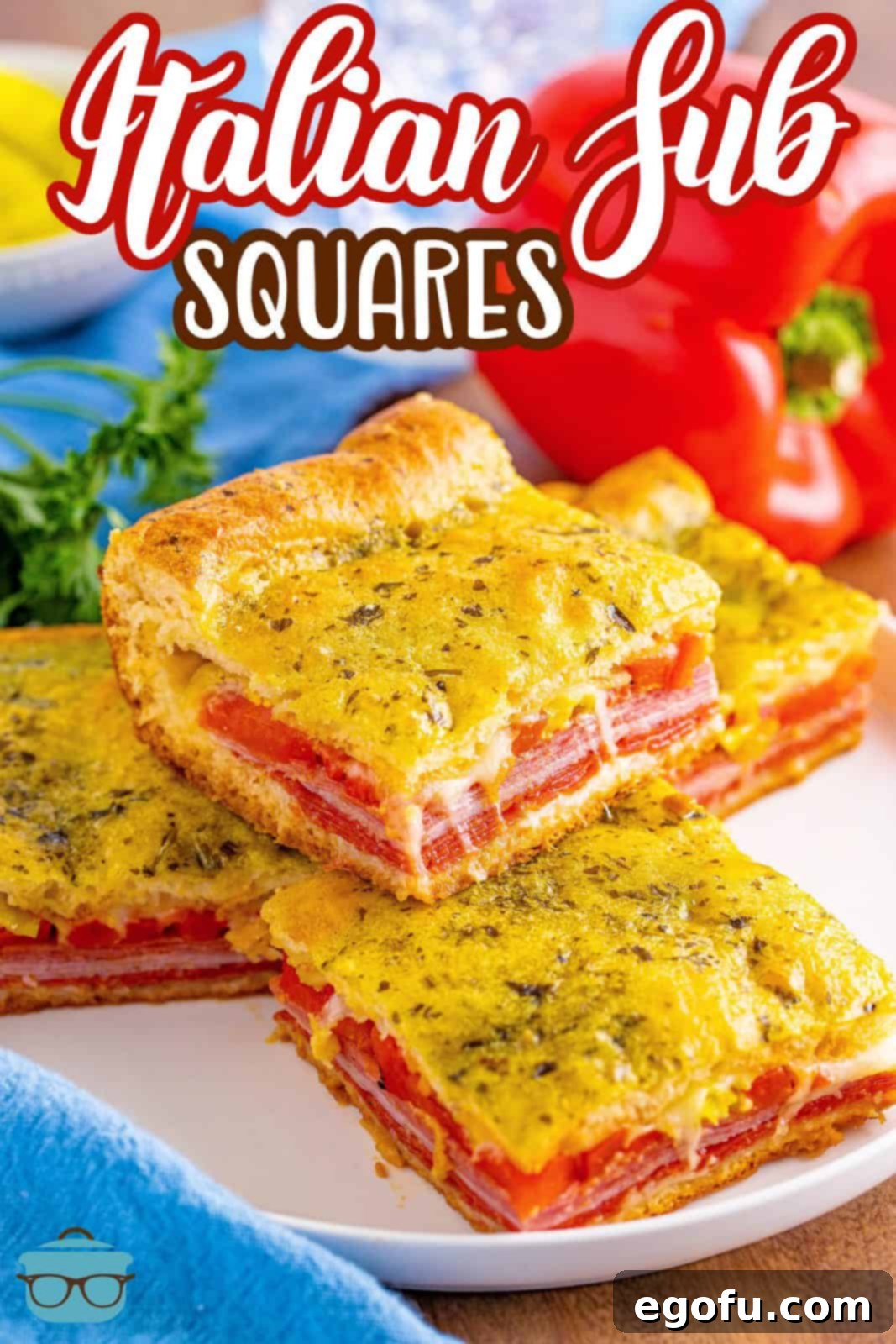 Several Italian Sub Squares stacked neatly on a white plate, ready to be served and enjoyed.