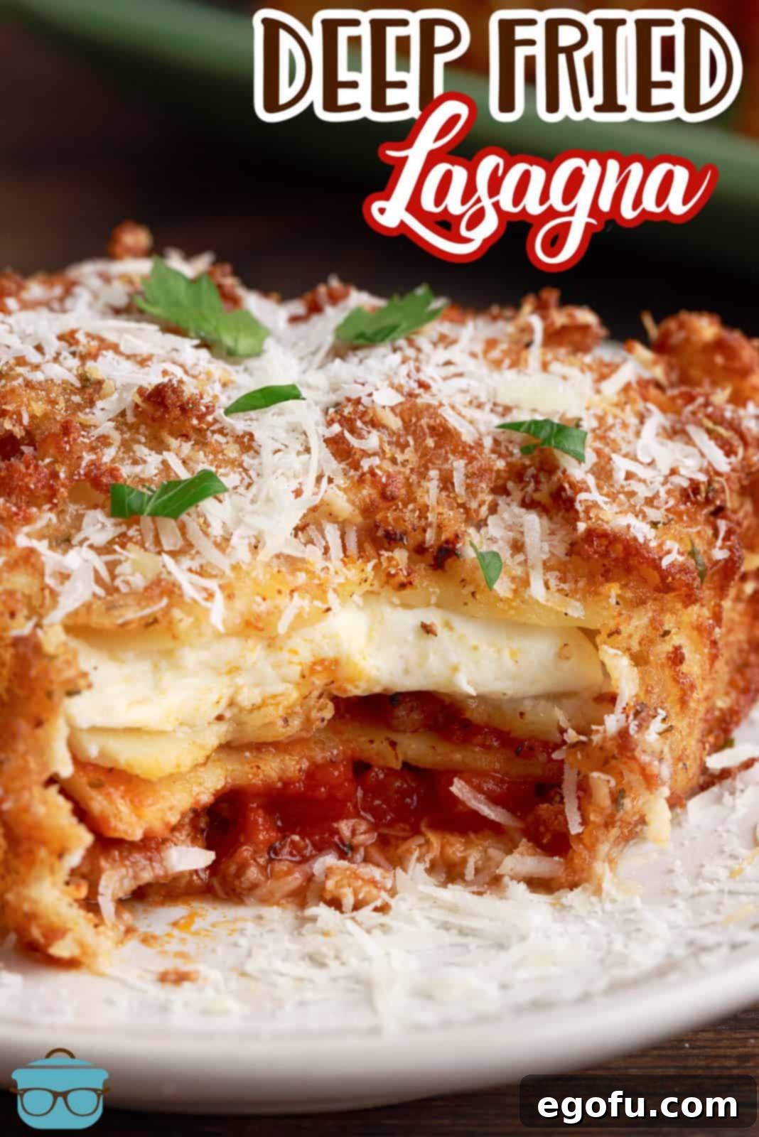 A bite-sized piece of Deep Fried Lasagna, perfect for Pinterest, showing the layers of cheese and noodles within the crispy crust.