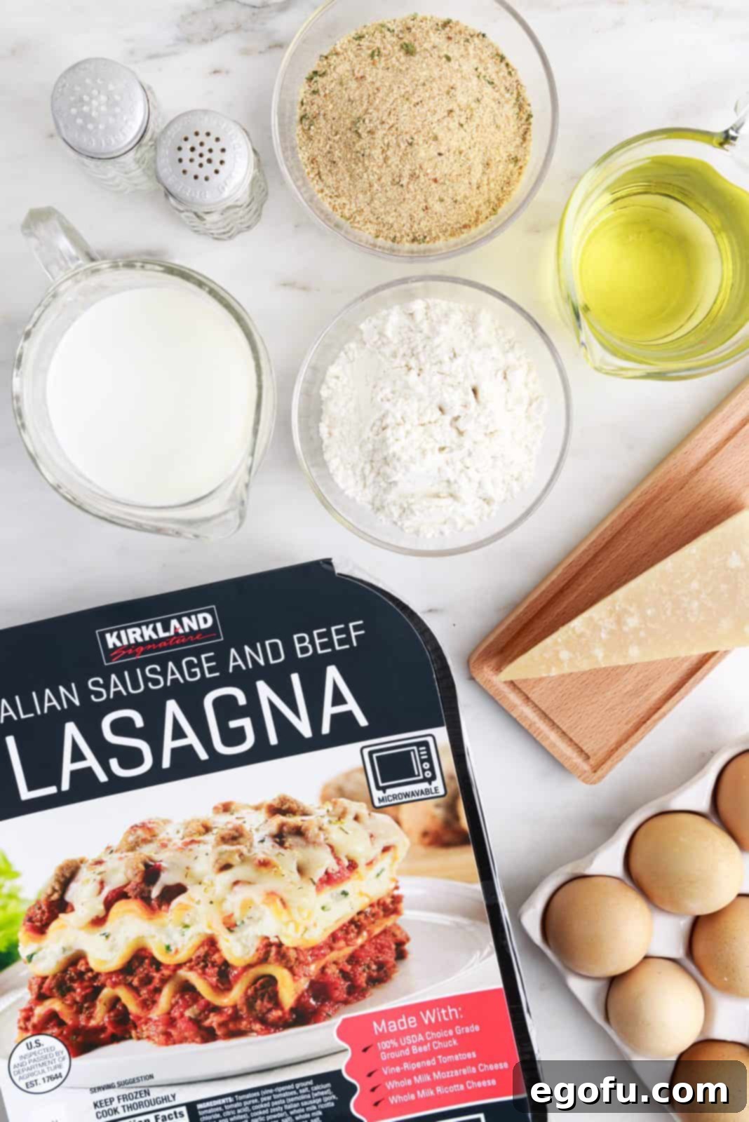 A visual display of all the key ingredients needed for Deep Fried Lasagna: frozen lasagna, all-purpose flour, salt, pepper, milk, eggs, Italian herb breadcrumbs, grated Parmesan cheese, vegetable oil or shortening, and fresh parsley.