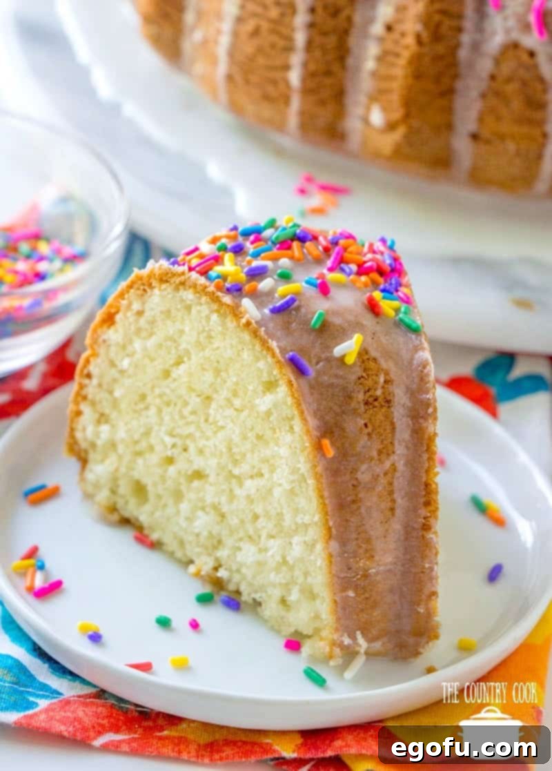 slice, vanilla melted ice cream bundt cake on a small white plate.