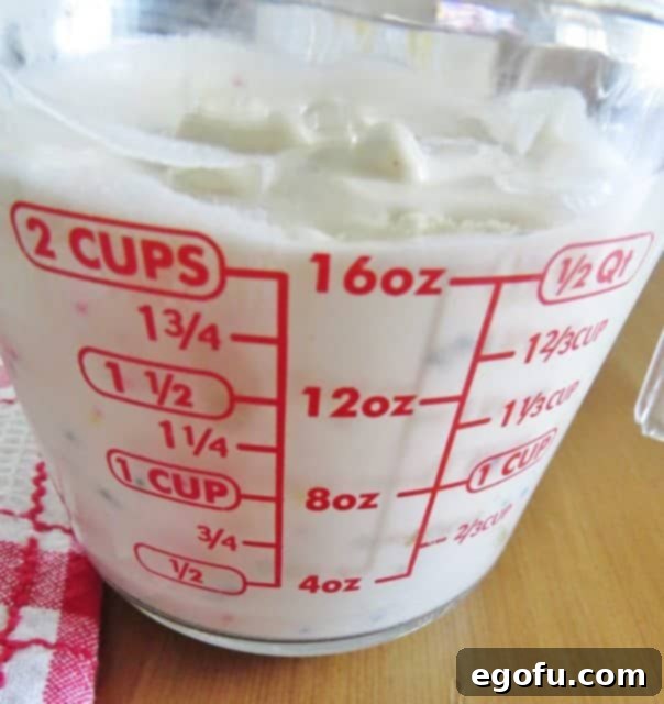 measuring melted ice cream in a measuring cup.