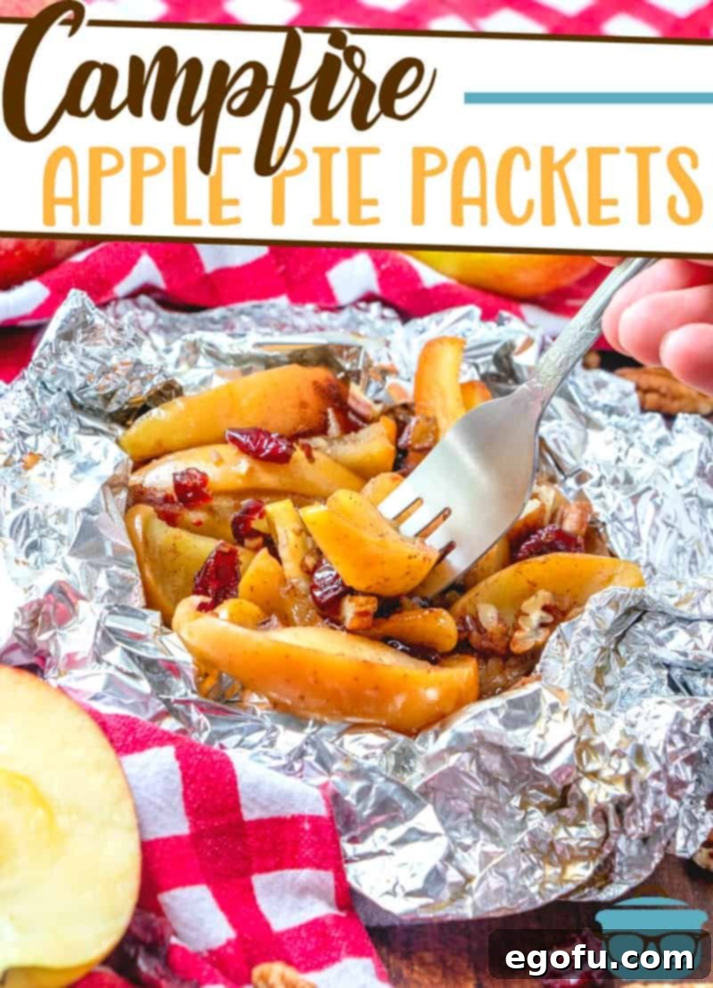 Campfire Apple Pie Packets recipe from The Country Cook, pictured cooked in aluminum foil and served with a fork.