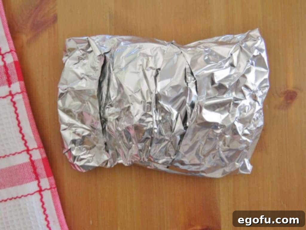 apples wrapped up in aluminum foil waiting to be cooked.