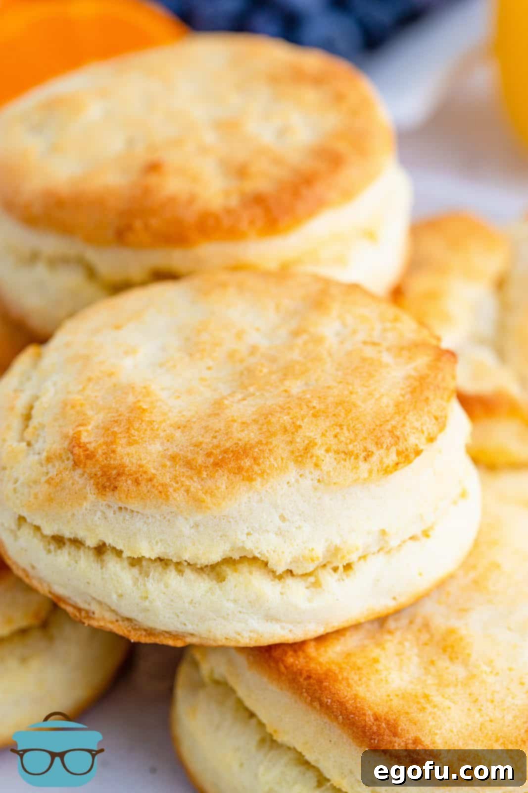 A beautiful closeup photo of a stack of golden brown, fluffy homemade 2-ingredient cream biscuits, ready to be served.