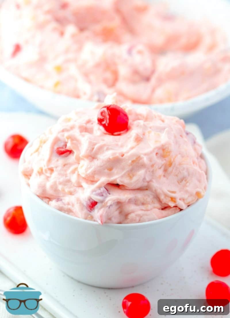 Easy Cherry Pie Fluff recipe in a bowl topped with maraschino cherries.