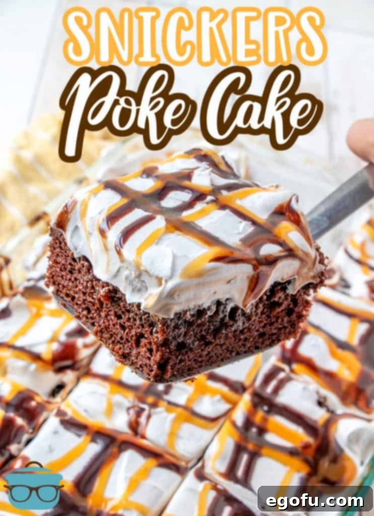 Snickers Poke Cake recipe from The Country Cook, slice of cake being removed with a spatula and shown being held over finished cake
