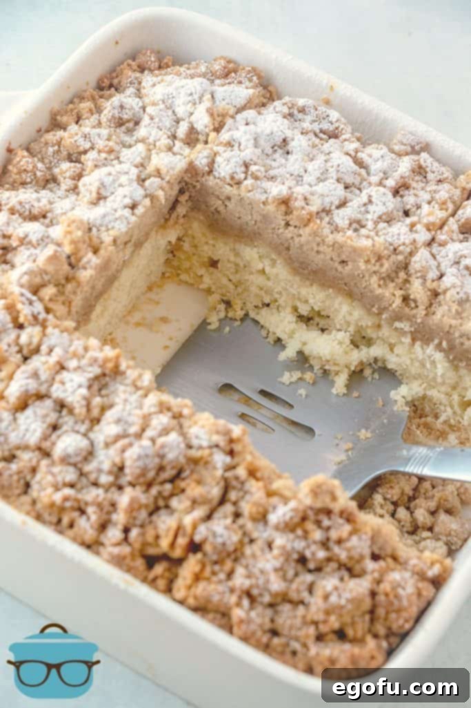 sliced double crumb cake showing the inside of the cake with a spatula resting on the side. 