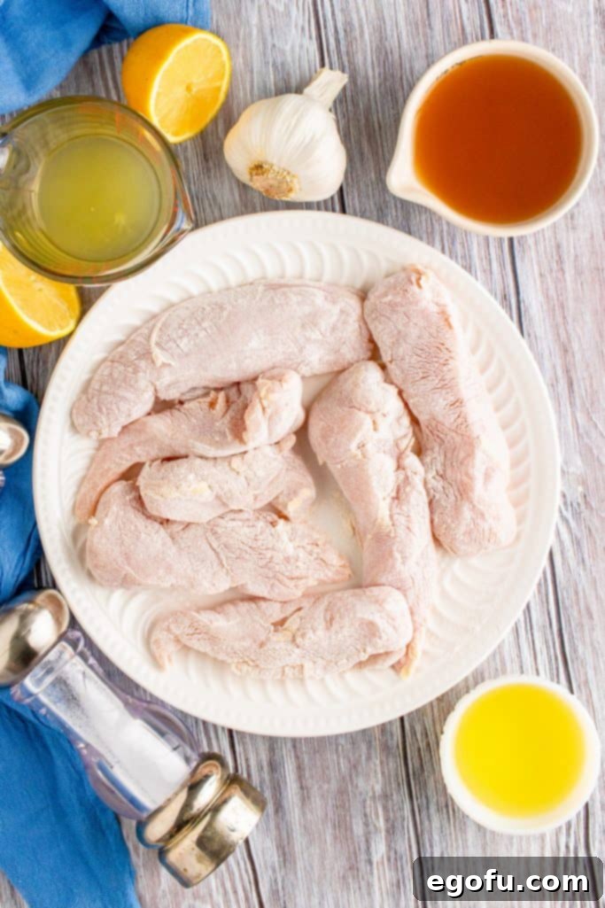 Zesty Slow Cooker Lemon Garlic Chicken 6 coating chicken breasts in flour in a shallow bowl.