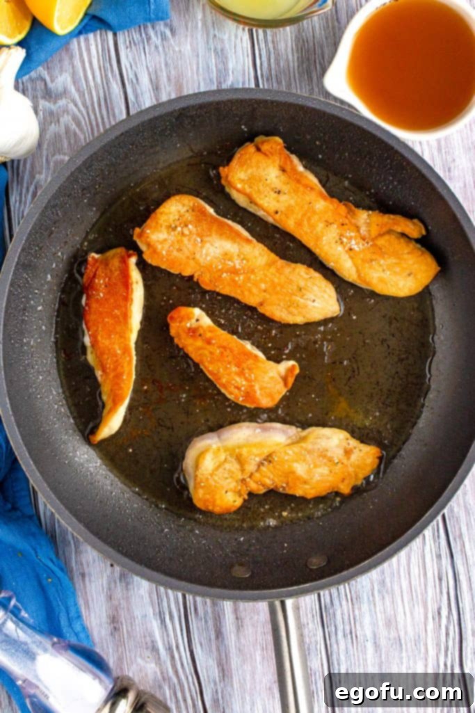 Zesty Slow Cooker Lemon Garlic Chicken 7 browning chicken in a hot pan with oil.