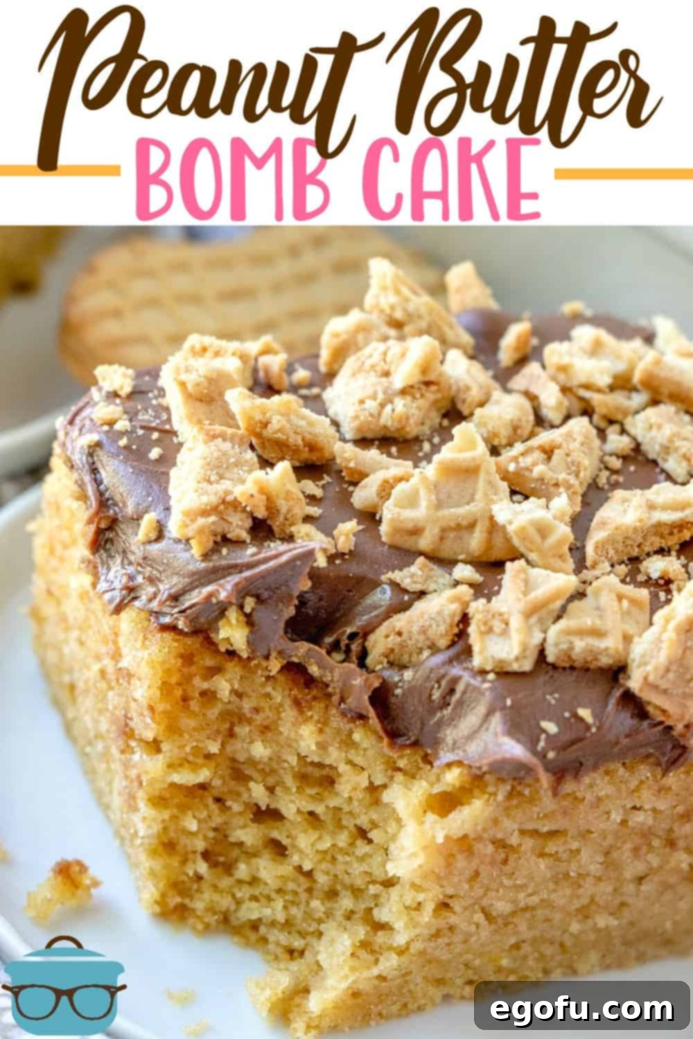 Close-up side view of a generous slice of Peanut Butter Bomb Cake, revealing its layers of moist cake, creamy frosting, and crunchy Nutter Butter topping.