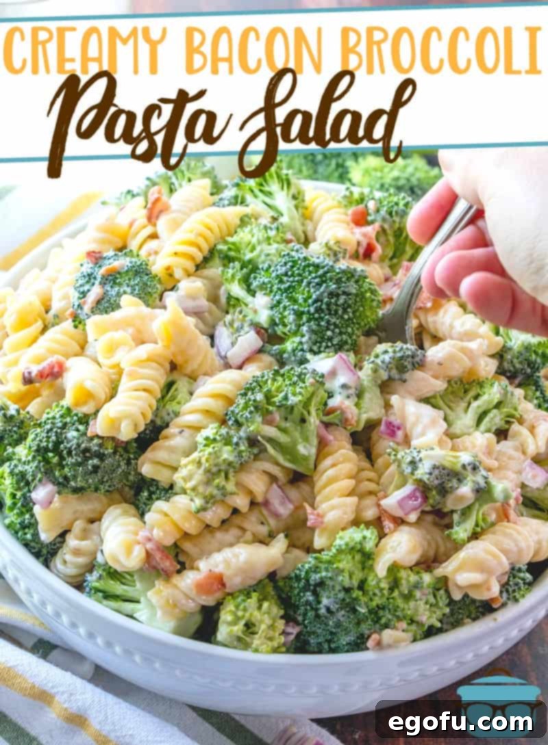 Creamy Bacon Broccoli Pasta Salad recipe from The Country Cook, served in a white bowl with the title of the recipe at the top of the photo.