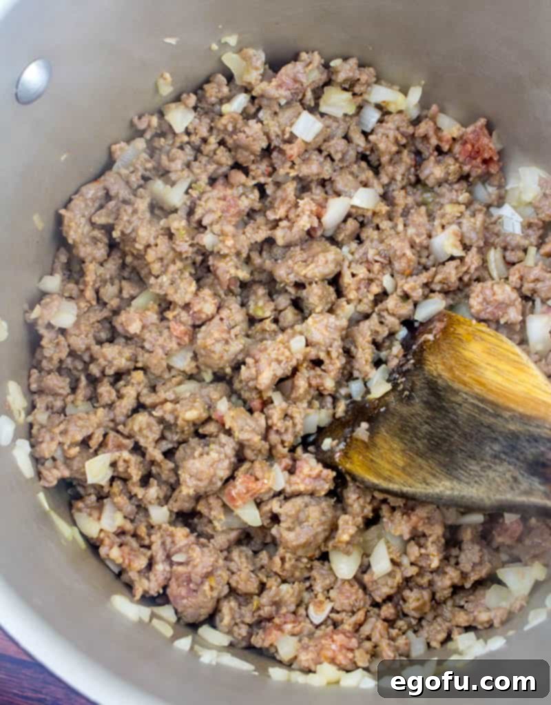 The Ultimate Copycat Olive Garden Zuppa Toscana Recipe 5 browning ground beef, Italian sausage and onions in a large stock pot.