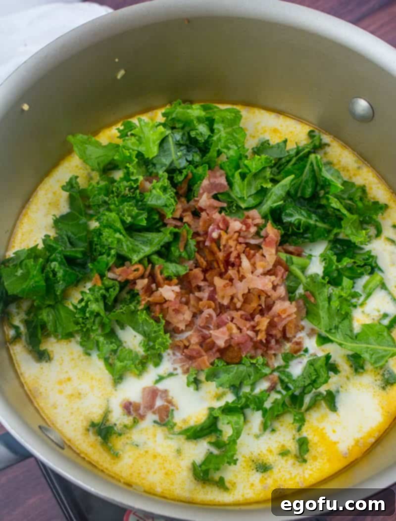 The Ultimate Copycat Olive Garden Zuppa Toscana Recipe 8 chopped kale and chopped bacon added into stock pot.