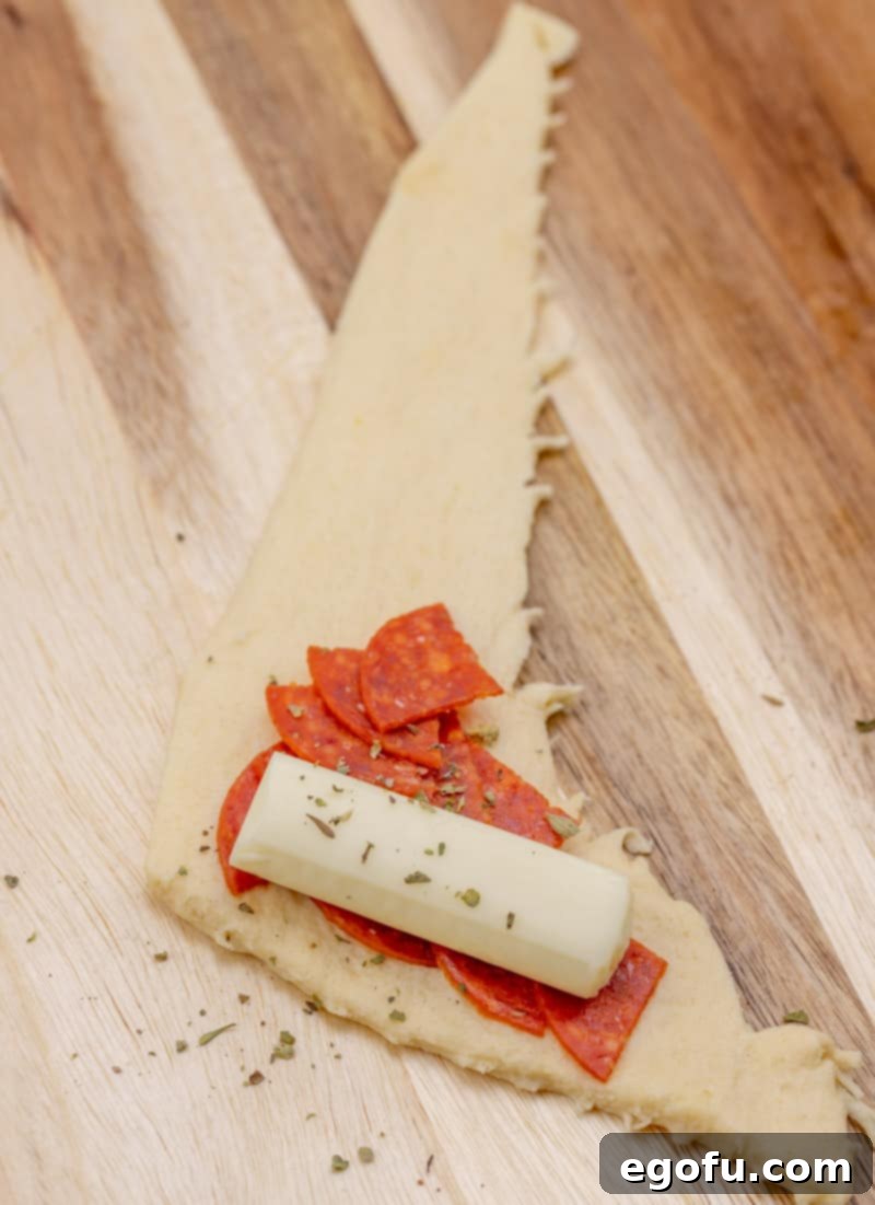 string cheese and pepperoni on a slice of crescent roll.