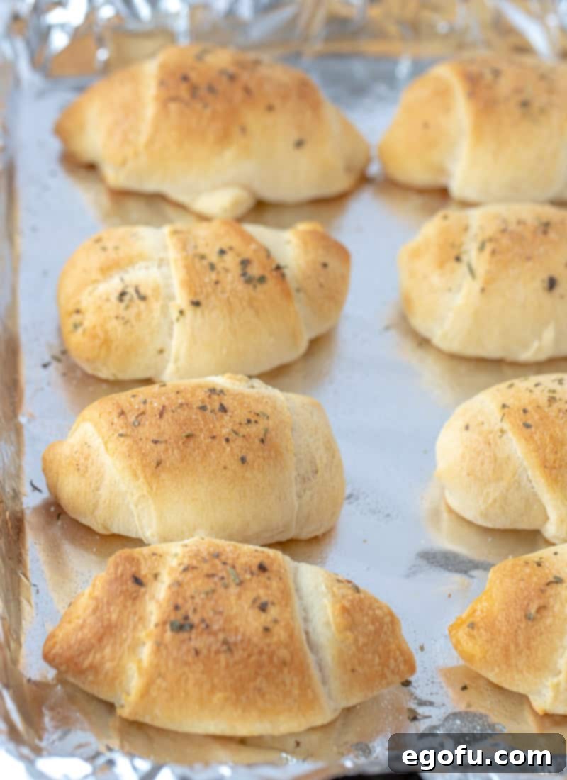 Crescent Pepperoni Roll Ups fully baked on a baking sheet.