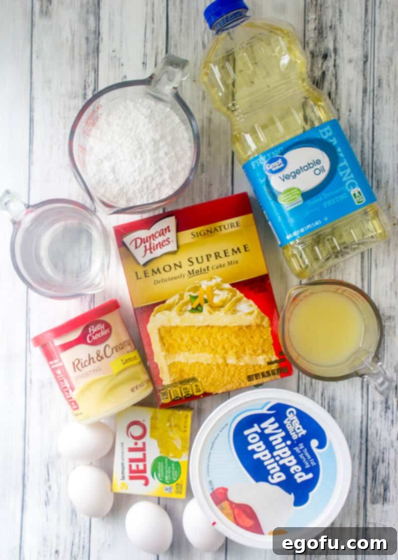 Zesty Lemon Drop Bliss 4 Key ingredients for Lemon Drop Cake including lemon cake mix, lemon Jell-O, lemon frosting, whipped topping, lemon juice, and powdered sugar, neatly arranged.