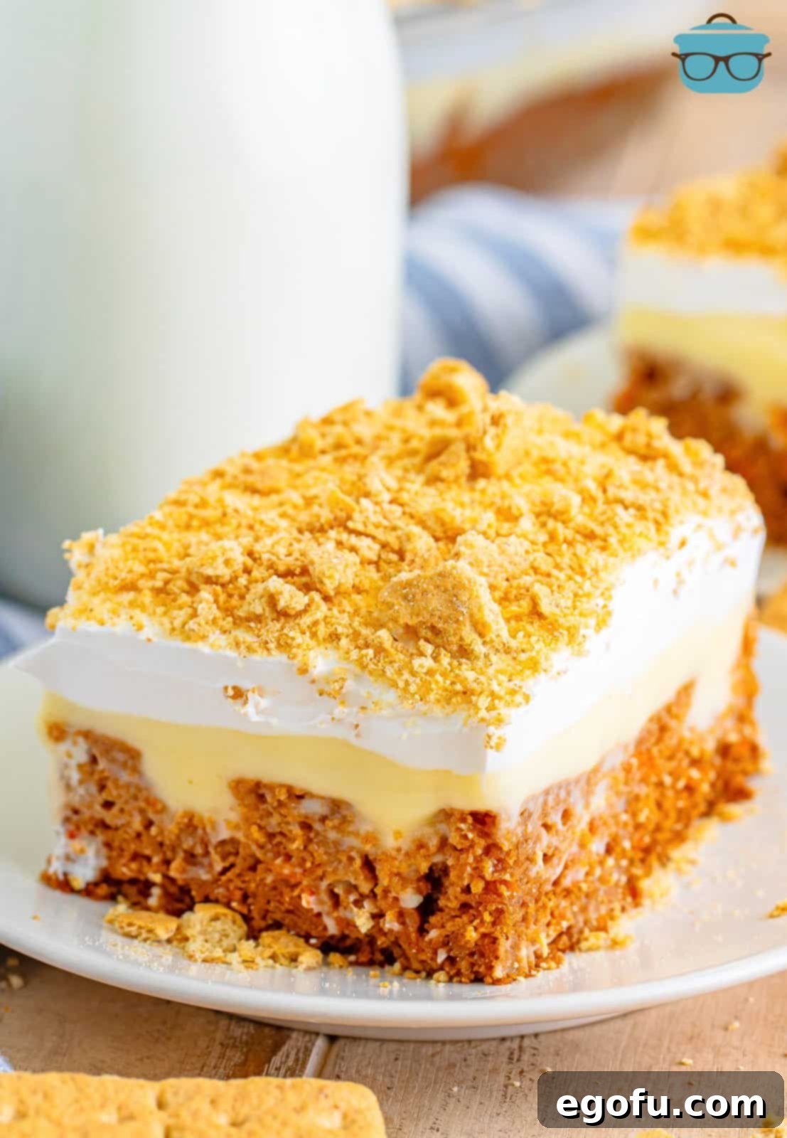 Super Moist Carrot Poke Cake 9 A big slice of Carrot Poke Cake on a dessert plate.