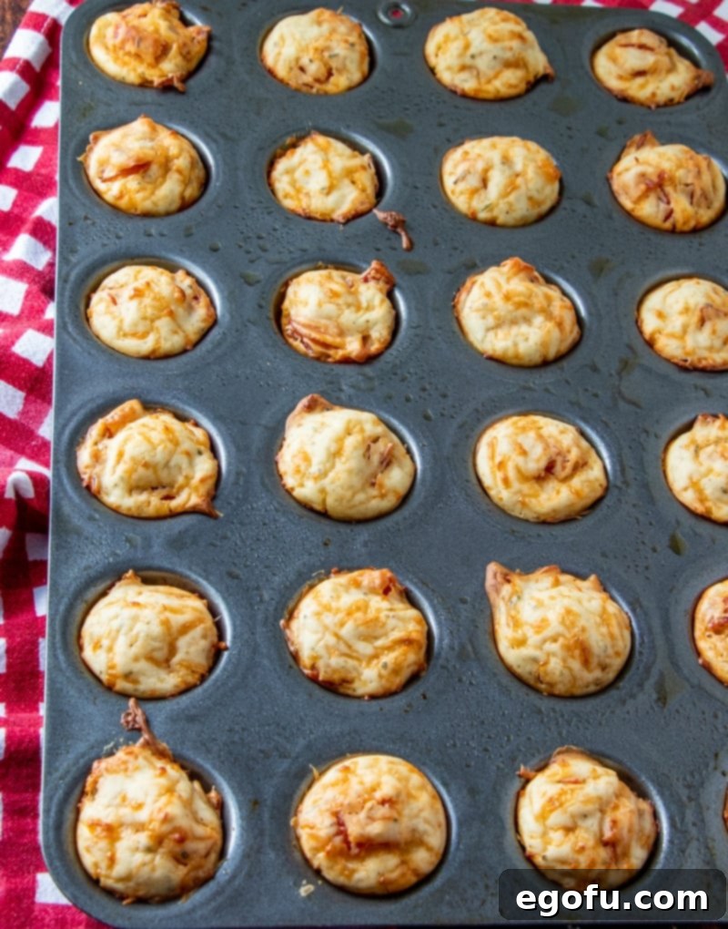 Cheesy Pepperoni Poppers 10 fully baked pepperoni puffs in a mini muffin tin.