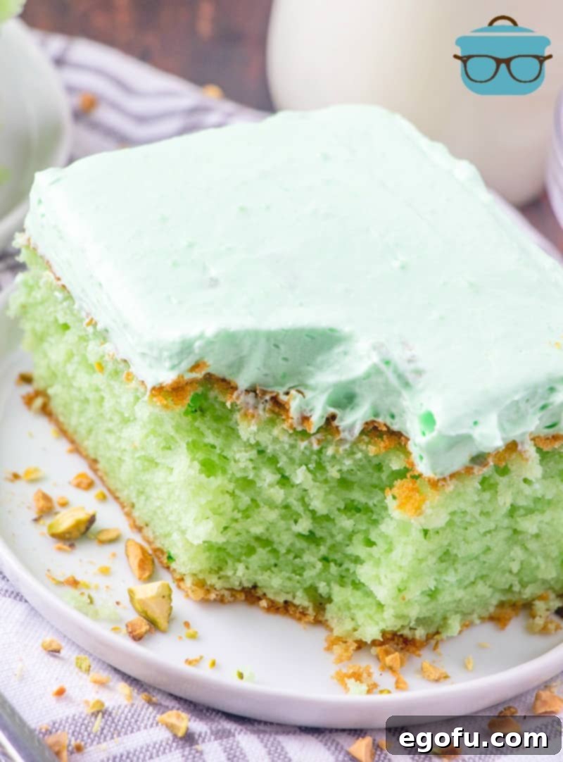 Bite taken out of Pistachio Cake.