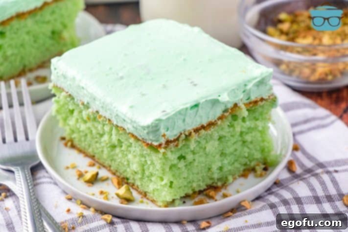 slice, easy green pistachio cake on a white plate
