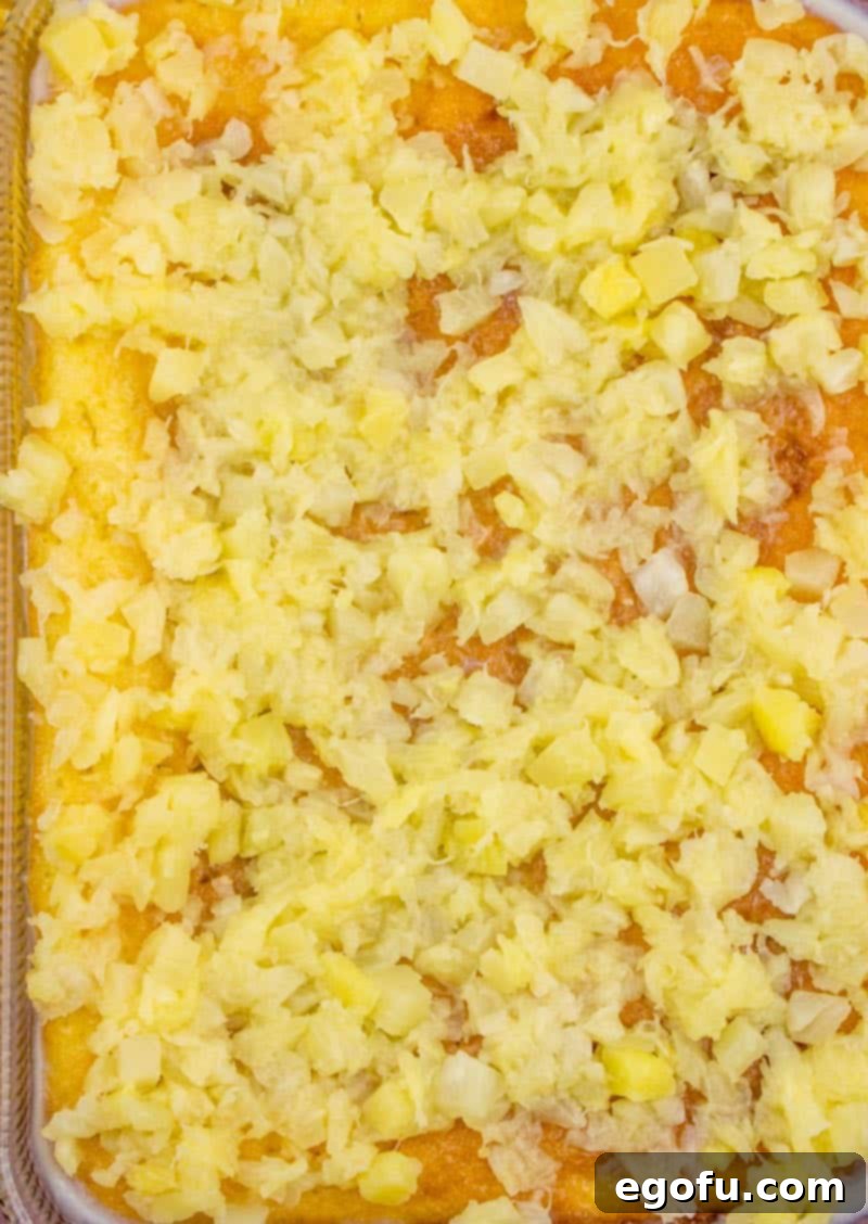 Piña Colada Paradise Poke Cake 10 Drained crushed pineapple spread over the top of the baked and saturated butter cake.