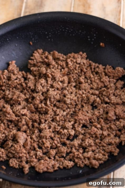 Cooked ground beef in a skillet.