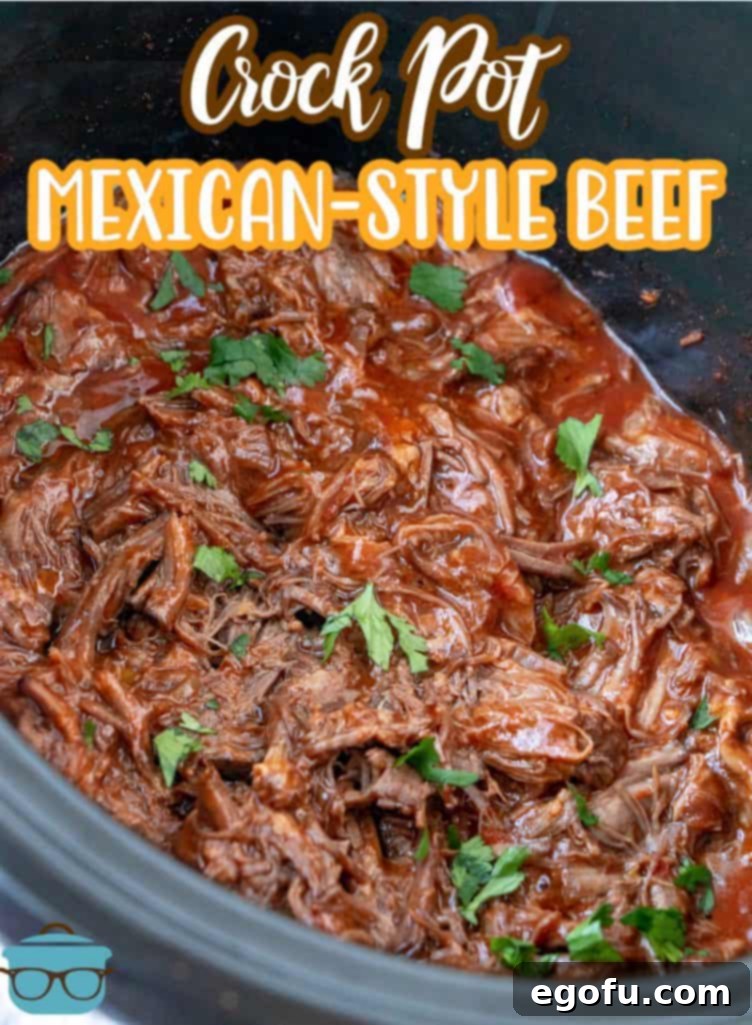 Fiesta-Ready Slow Cooker Shredded Beef 3 Close-up of freshly cooked Crock Pot Mexican Shredded Beef in a slow cooker, garnished with a sprinkle of chopped cilantro, highlighting its tender texture and rich, savory appearance.