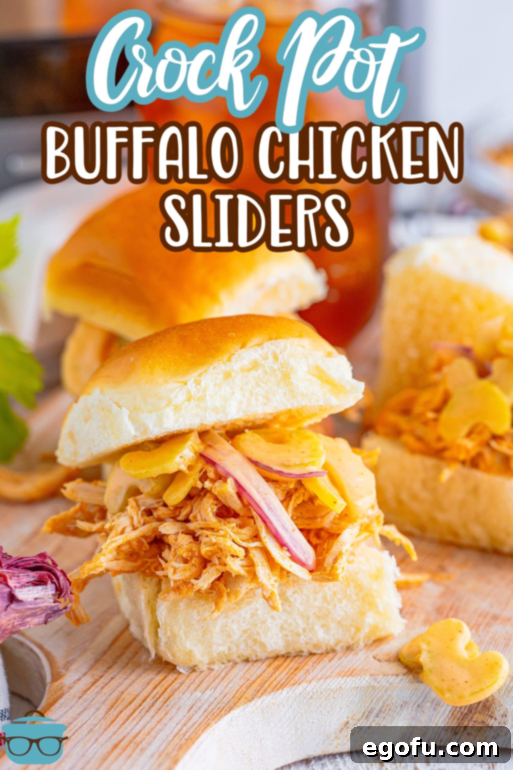 A closer look at two perfectly assembled Buffalo Chicken Sliders, highlighting the juicy shredded chicken, fresh slaw, and soft slider buns.