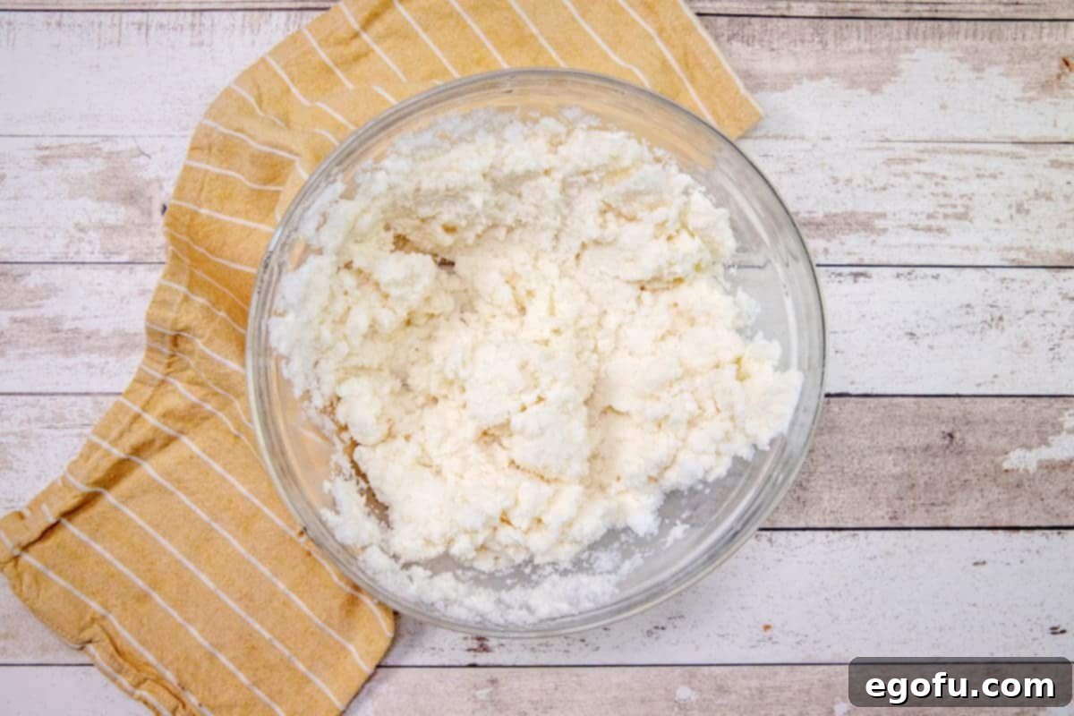 fully mixed snow ice cream in a clear bowl, showcasing the smooth, creamy texture.