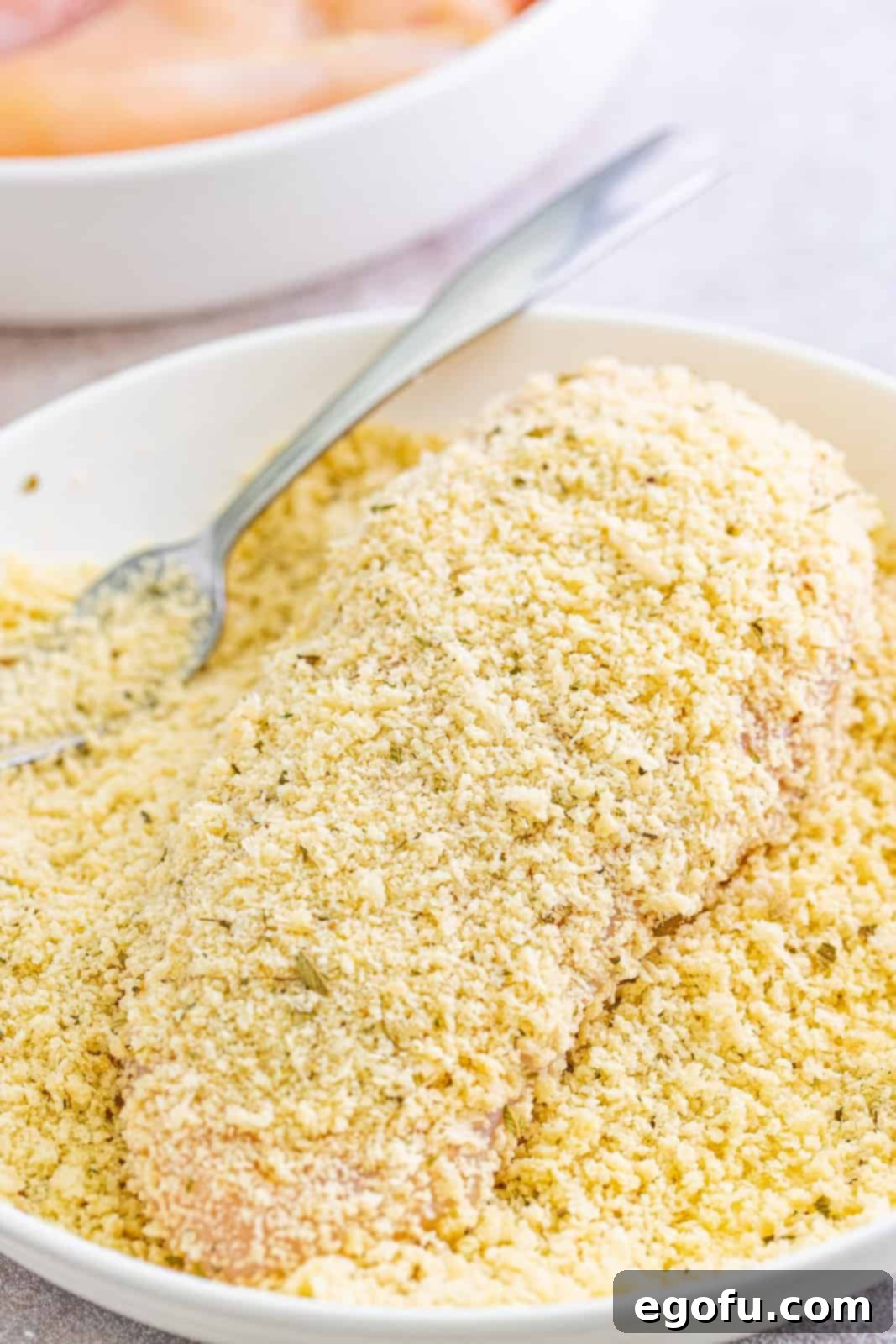 Slow Cooker Chicken Parm Perfection 10 A chicken breast being thoroughly coated in the seasoned Panko bread crumb mixture.