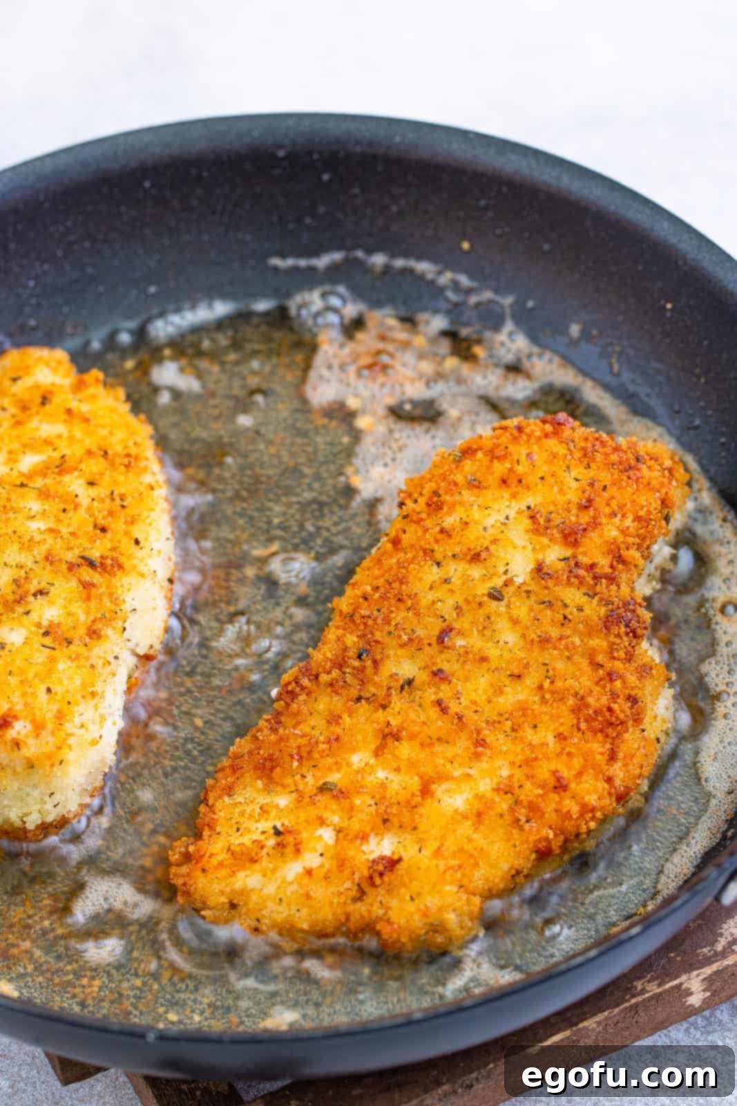 Slow Cooker Chicken Parm Perfection 11 Chicken breasts browning in a hot skillet, developing a golden, crispy crust.