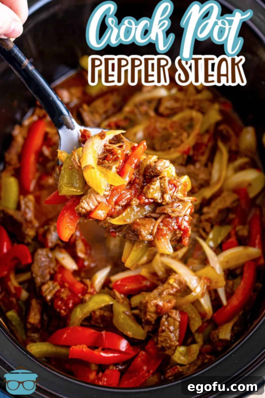 Slow Cooker Pepper Steak 3 A large serving spoon lifts a portion of pepper steak over a black, oval crock pot, showing the rich sauce and tender ingredients.