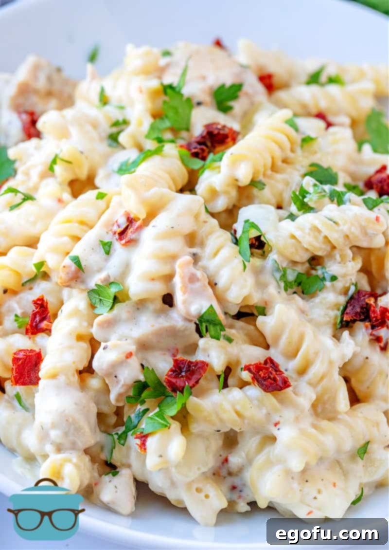 Creamy Italian Chicken Pasta shown close up in a white serving bowl.