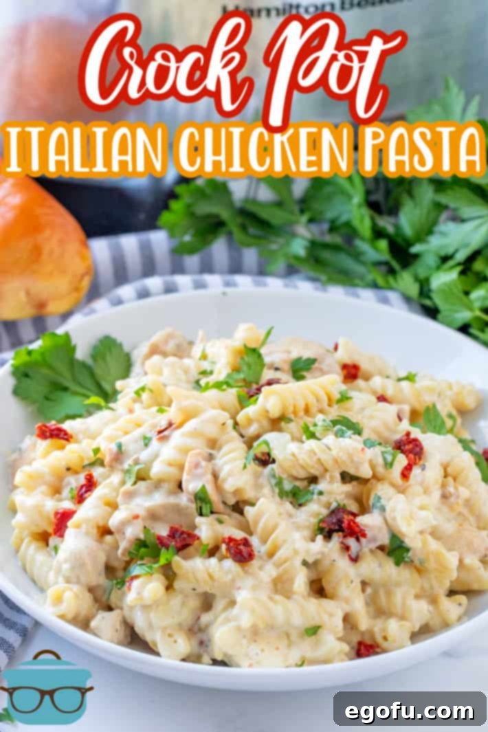 Crock Pot Creamy Italian Chicken Pasta recipe from The Country Cook, serving of pasta shown in a white bowl with fresh parsley in the background.