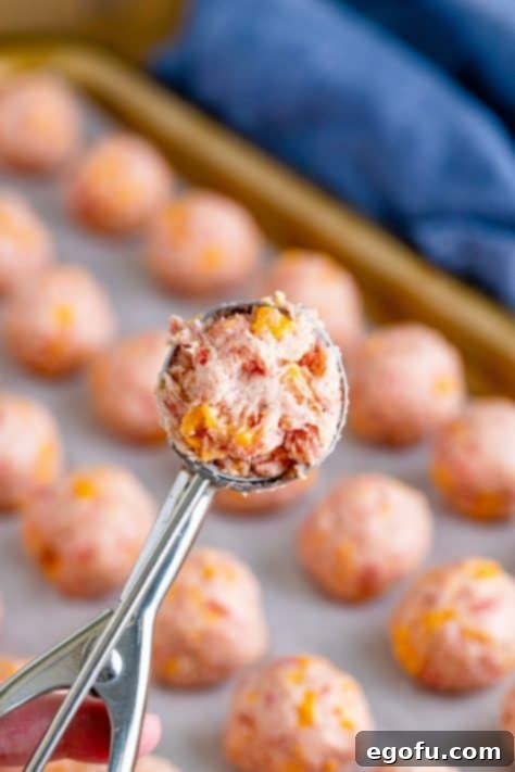 Cream Cheese Sausage Poppers 13 spring loaded scoop with cream cheese sausage mixture.