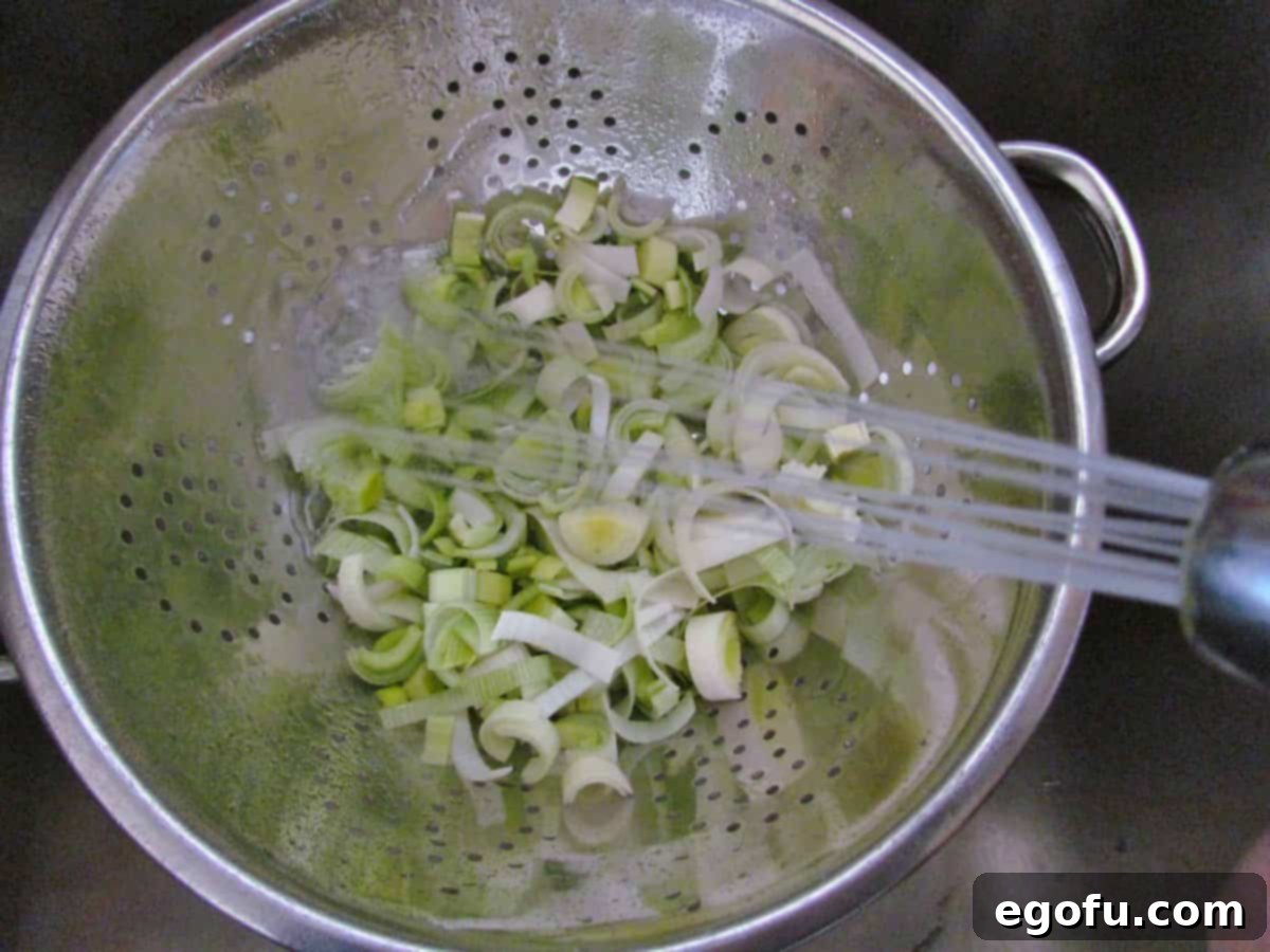 rinsing leeks in a colander.