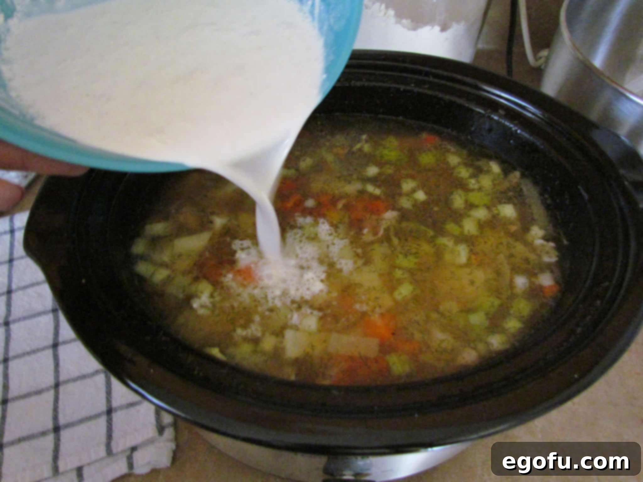 adding half and half into potato leek soup.