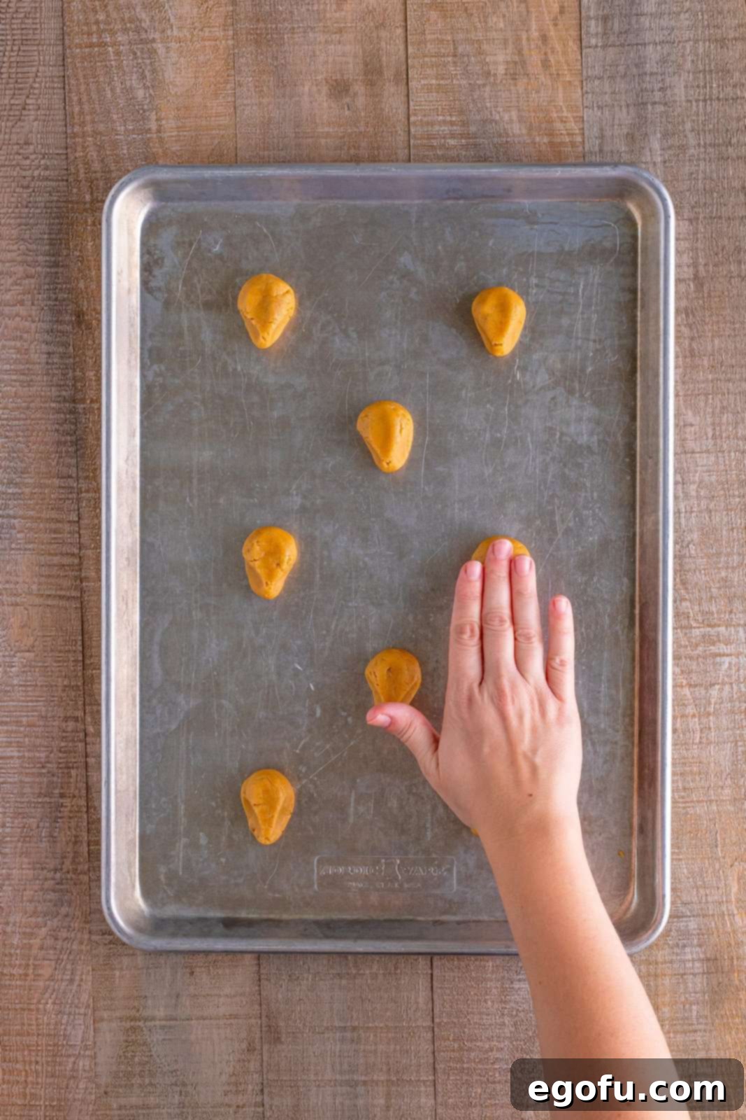 Red Nosed Reindeer Treats 11 slightly smooshing down the cookie down with a hand.