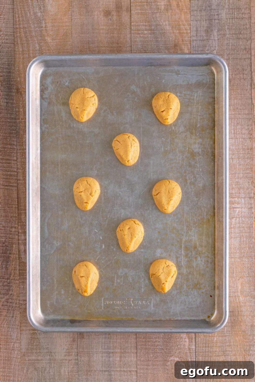 Red Nosed Reindeer Treats 12 fully baked peanut butter cookies n a baking tray.